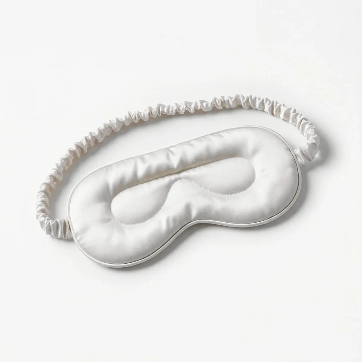 The inside of the Weighted Eye Mask in Ivory: the sewn contour around the eyes, recessed into the padding