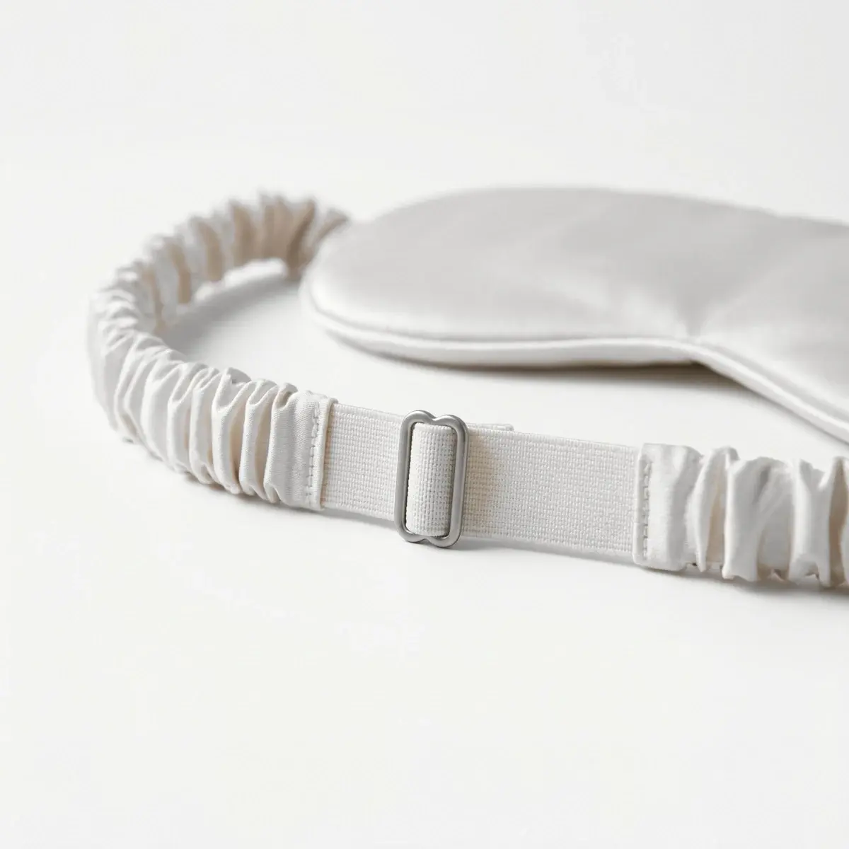 The strap's gathered cover slid back to show the elastic and the slider that adjusts it