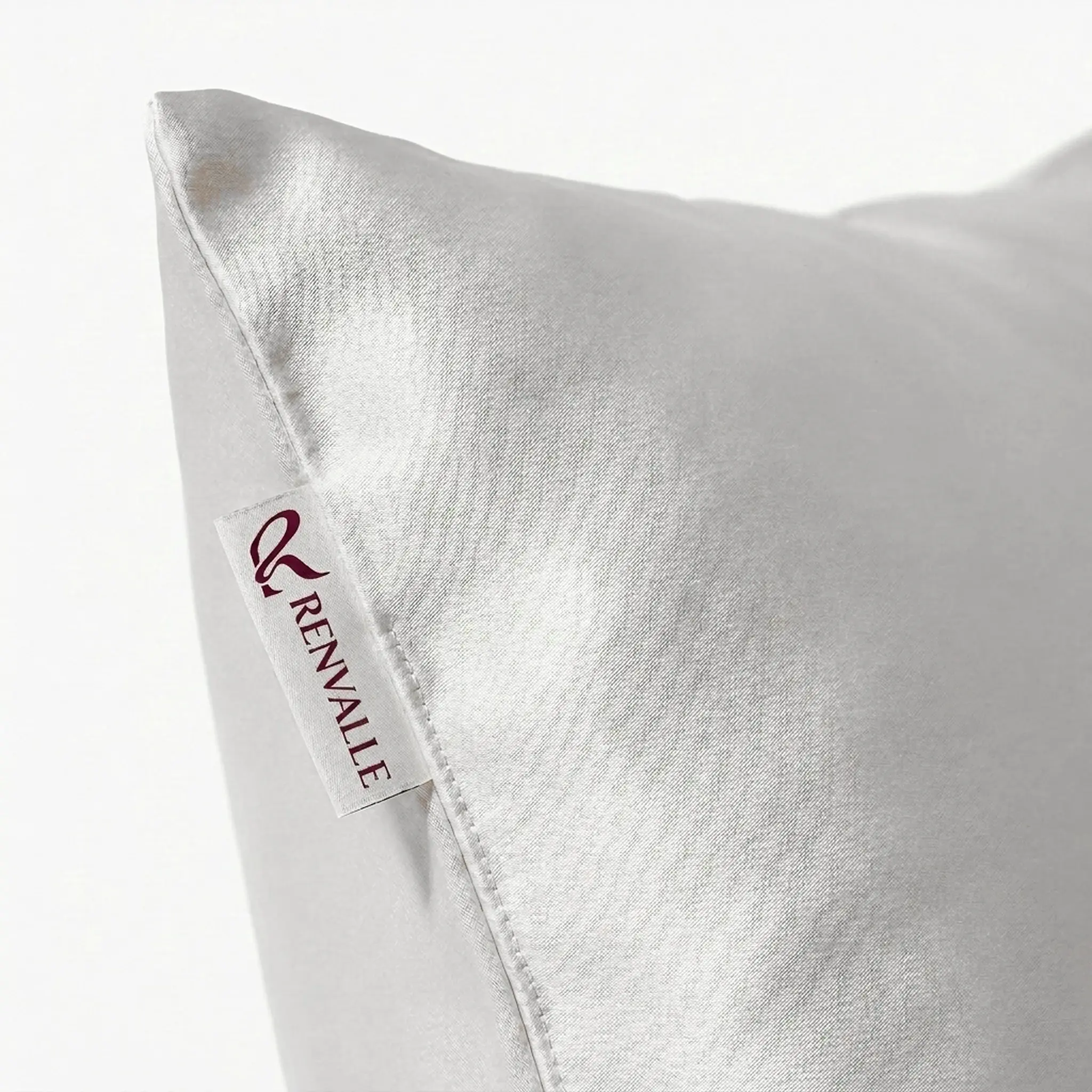 Close-up of the woven Renvalle label sewn into the Ivory pillowcase's side seam